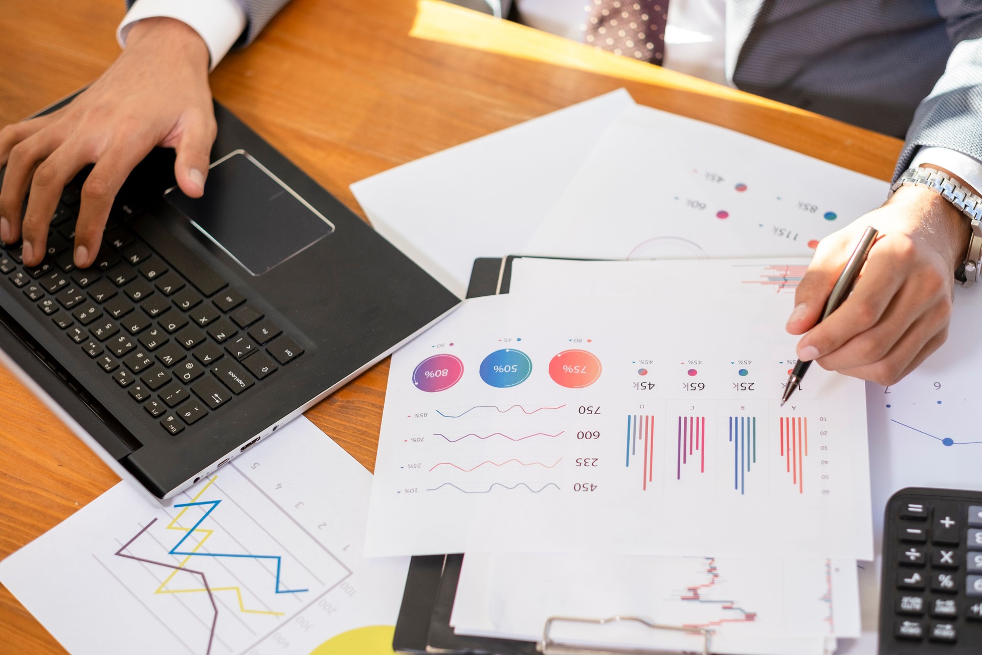 Unrecognizable Businessman Sitting at the Office Analyzing Financial Reports
