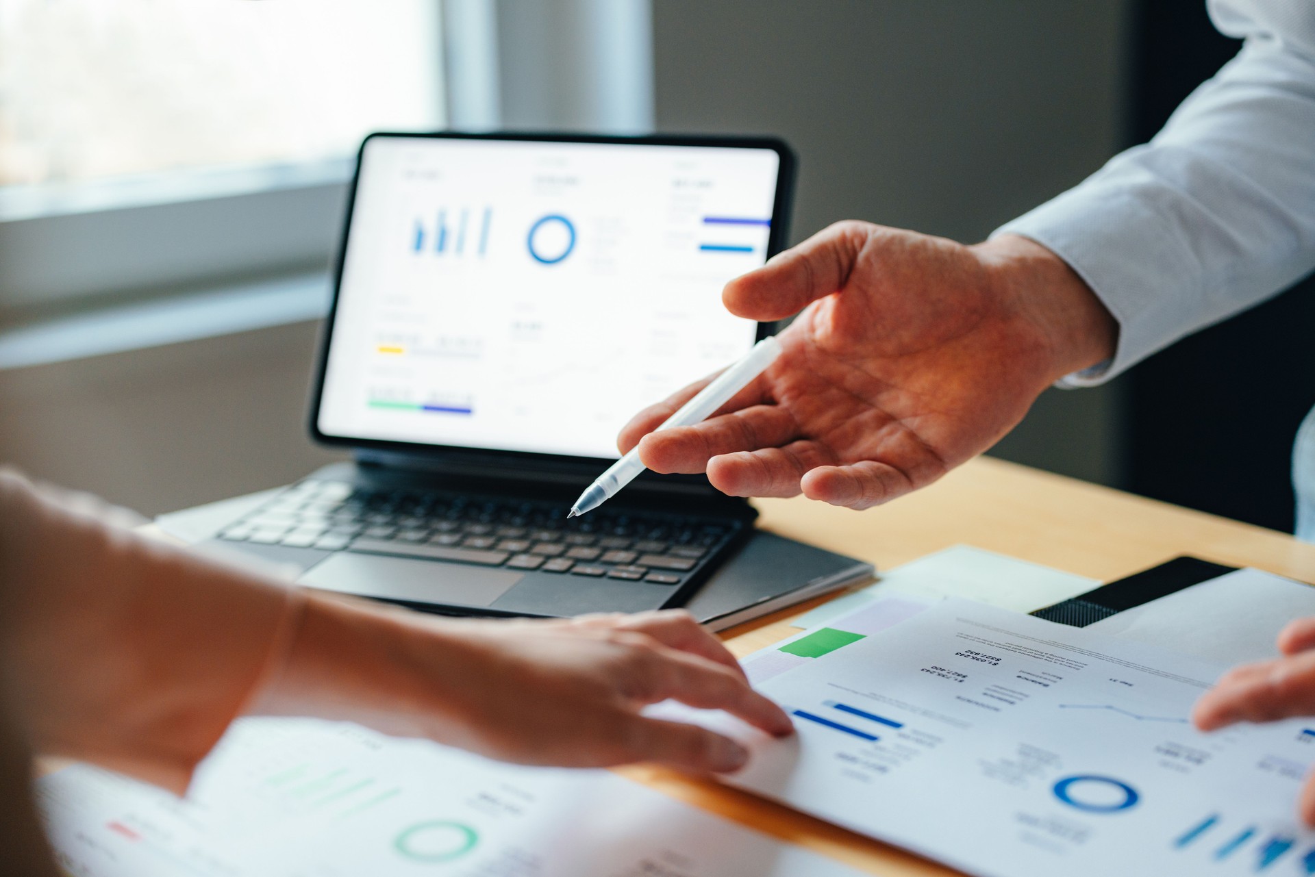 Anonymous Businesspeople Analyzing Business Graphs and Documents Together